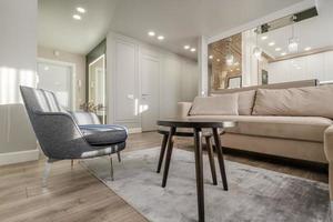 comfortable chairs and table with flowers  in interior the modern living room photo