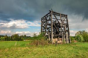 remains of old burnt windmill in the field before the rain photo