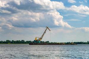 huge digger in quarry  for sand extraction mining in lake photo