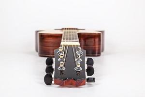 Tuning pegs on wooden machine head of six strings guitar on white background photo