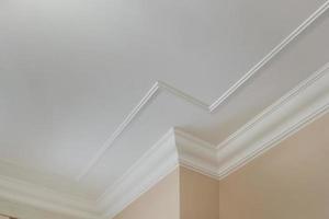 Detail of corner ceiling cornice with intricate crown molding. photo