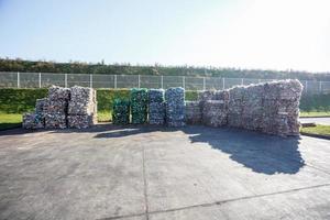 Plastic bales of rubbish at the waste treatment processing plant. Recycling separatee and storage of garbage for further disposal, trash sorting. Business for sorting and processing of waste. photo