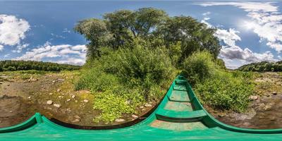 full spherical seamless hdri panorama 360 degrees angle view on green wooden old boat on dry river bank near the forest in sunny summer day in equirectangular projection, VR content photo