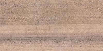 view from above on texture of gravel road with car tire tracks photo