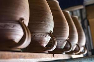 row of ceramic jugs are on the shelf photo