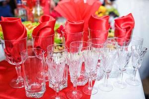View of the served for decorated wedding dinner table with glasses  in the restaurant photo