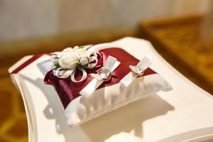 rings of newlyweds on the decorative pillow photo