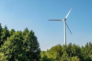 rotating blades of a windmill propeller. Wind power generation. Pure green energy. photo