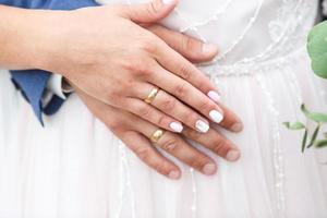 The bride and groom in nature. Hands of newlyweds. Wedding day. The best day of a young couple photo