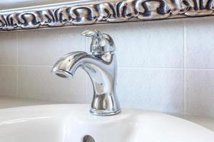 Water tap sink with faucet in expensive loft bathroom photo