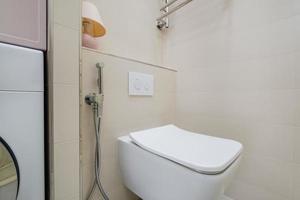 bidet in modern toilet with  wall mount shower attachment photo