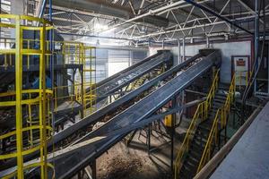 moving conveyor transporter on Modern waste recycling processing plant. Separate and sorting garbage collection. Recycling and storage of waste for further disposal. photo