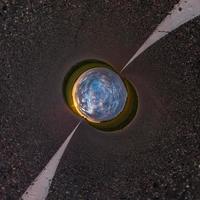 Little planet transformation of spherical panorama 360 degrees. Spherical abstract aerial view in field with awesome beautiful clouds. Curvature of space. photo