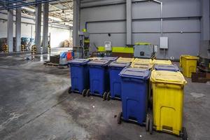 Containers with used bottles and  plastic bales of rubbish at waste treatment processing plant. Recycling separatee and storage of garbage for further disposal, trash sorting. photo