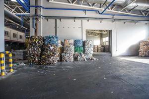 Plastic bales of rubbish at the waste treatment processing plant. Recycling separatee and storage of garbage for further disposal, trash sorting. Business for sorting and processing of waste. photo