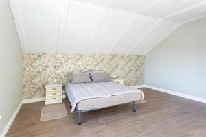 Double bed in interior of the modern bedroom in loft flat in light color style of expensive apartments photo