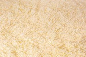 Faux fur background texture close-up light color. Artificial fur with short pile blank background photo