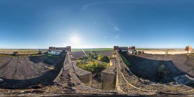 Aerial full spherical seamless panorama 360 degrees angle view with roof concrete abandoned unfinished building. 360 panorama  in equirectangular equidistant projection, VR AR content photo