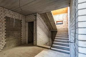 empty interior in house without repair with white silicate brick walls photo