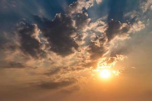 Blue sky background with evening fluffy curly rolling altocumulus altostratus clouds with setting sun. Good windy weather photo