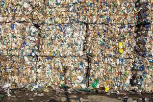 Plastic bales at the waste processing plant. Separate garbage collection. Recycling and storage of waste for further disposal. Business for sorting and processing of waste. photo