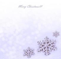 Glass toy snowflake on snow background. photo