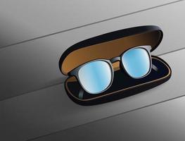gafas de lente azul en una caja negra sobre un suelo de madera