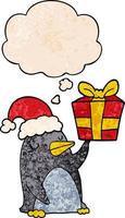 cartoon penguin with christmas present and thought bubble in grunge texture pattern style vector