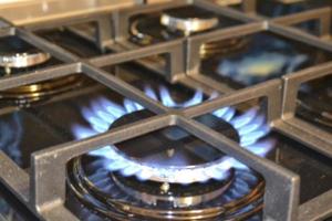 Blurred background. Blue gas flame on the gas stove photo