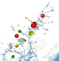 fruit in a spray of water isolated on white background photo