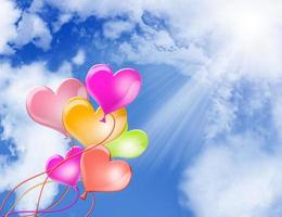 Love heart balloons on sky background photo