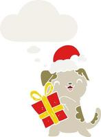 lindo cachorro de dibujos animados con regalo de navidad y sombrero y burbuja de pensamiento en estilo retro vector