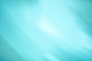 Turquoise blue background banner with white light in the middle. Lines and waves. Abstraction photo
