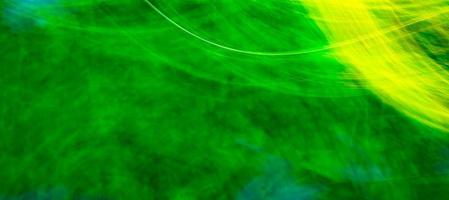 Abstract, bright green background with a yellow tint, glowing waves and lines photo