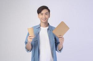 Young asian man holding paper cup and paper box over white background, Save earth concept photo