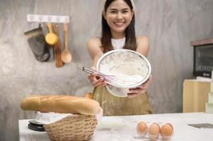 Young beautiful woman is baking in her kitchen , bakery and coffee shop business photo