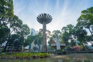 Wide angle view of Lotus pillar - An iconic architecture at Turtle lake , Ho Con Rua with blue sky in Saigon. photo