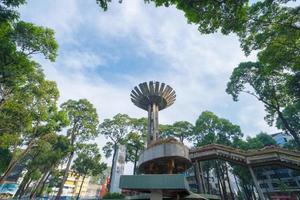 Wide angle view of Lotus pillar - An iconic architecture at Turtle lake , Ho Con Rua with blue sky in Saigon. photo