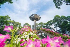 Wide angle view of Lotus pillar - An iconic architecture at Turtle lake , Ho Con Rua with blue sky in Saigon. photo