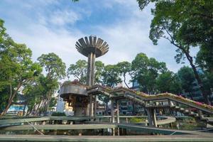 Wide angle view of Lotus pillar - An iconic architecture at Turtle lake , Ho Con Rua with blue sky in Saigon. photo