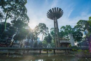 Wide angle view of Lotus pillar - An iconic architecture at Turtle lake , Ho Con Rua with blue sky in Saigon. photo