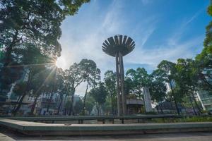 Wide angle view of Lotus pillar - An iconic architecture at Turtle lake , Ho Con Rua with blue sky in Saigon. photo