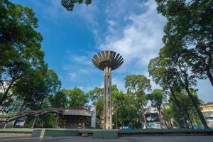 Wide angle view of Lotus pillar - An iconic architecture at Turtle lake , Ho Con Rua with blue sky in Saigon. photo