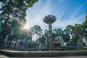 Wide angle view of Lotus pillar - An iconic architecture at Turtle lake , Ho Con Rua with blue sky in Saigon. photo