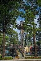 Wide angle view of Lotus pillar - An iconic architecture at Turtle lake , Ho Con Rua with blue sky in Saigon. photo