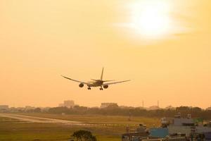 Ho Chi Minh city, Vietnam - FEB 20 2022 Airplane fly over urban areas preparing landing into Tan Son Nhat International Airport and takes off in TSN airport photo