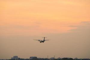 Ho Chi Minh city, Vietnam - FEB 20 2022 Airplane fly over urban areas preparing landing into Tan Son Nhat International Airport and takes off in TSN airport photo