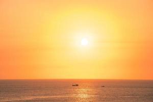 Beautiful sunset beach landscape, exotic tropical island nature, colorful red yellow sky, silhouette ship, golden sun glow reflection, summer holidays vacation. Sky cloud cinematic. photo