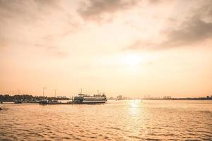 Ho Chi Minh, VIETNAM - FEB 19 2022 Transportation for export, import at Cat Lai port on Sai Gon river, crane load container to boat, this harbor is big industry service for trade photo