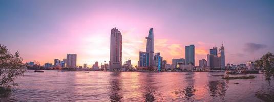 HO CHI MINH, VIETNAM - FEB 13 2022  View of Bitexco Financial Tower building, buildings, roads, Thu Thiem bridge and Saigon river in Ho Chi Minh city in sunset. High quality panorama image. photo